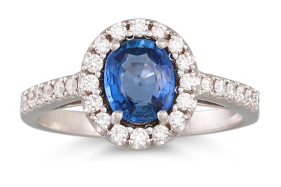 Lot 115 - A SAPPHIRE AND DIAMOND CLUSTER RING, the oval...