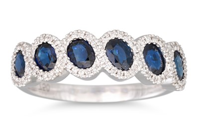 Lot 23 - A DIAMOND AND SAPPHIRE CLUSTER RING, mounted...