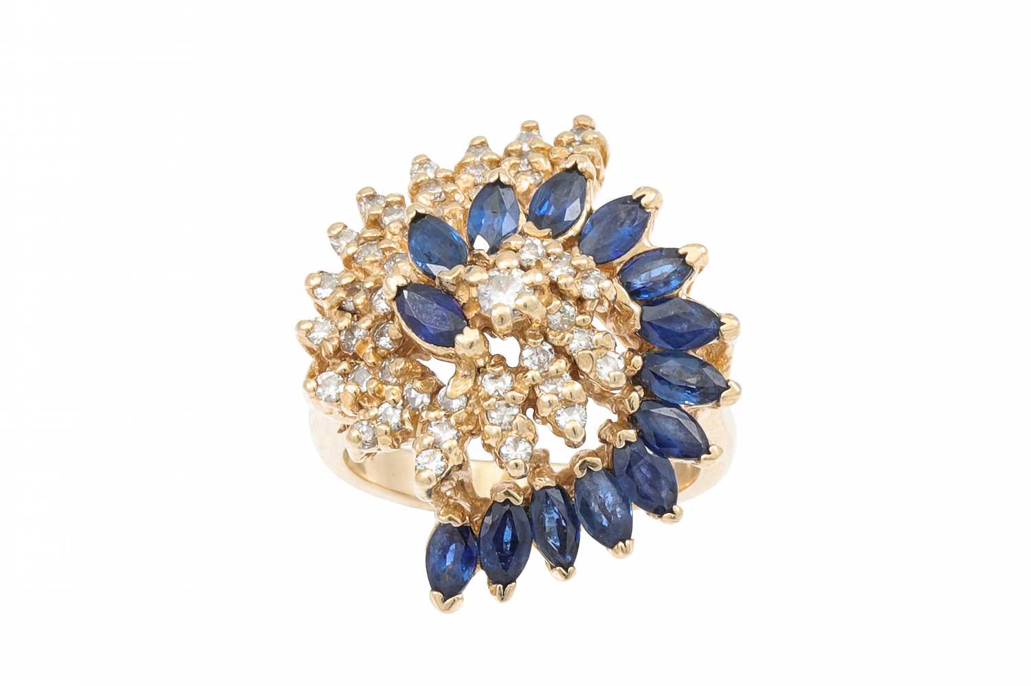 Lot 82 - A SAPPHIRE AND DIAMOND CLUSTER RING, of swirl...