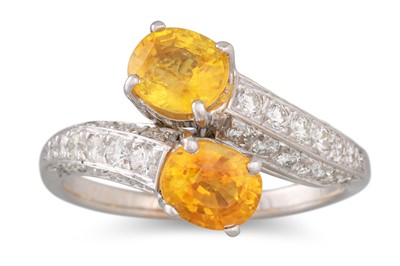 Lot 233 - A YELLOW SAPPHIRE AND DIAMOND CROSS-OVER RING,...