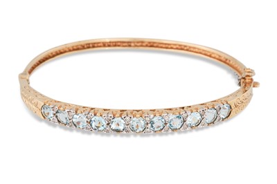 Lot 239 - A DIAMOND AND TOPAZ BANGLE, mounted in gold
