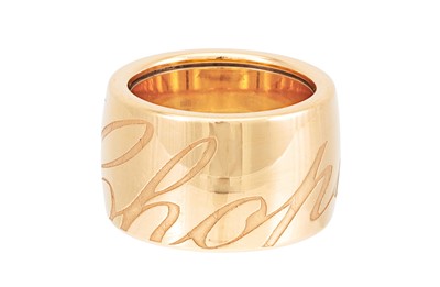 Lot 348 - A CHOPARD RING, the wide 18ct gold band...