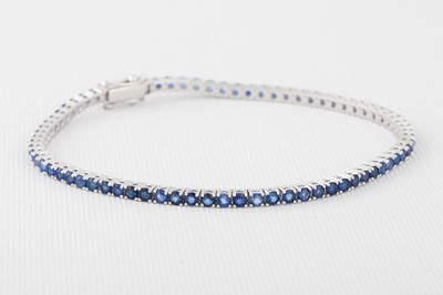 Lot 168 - A SAPPHIRE LINE BRACELET, mounted in 18ct gold....