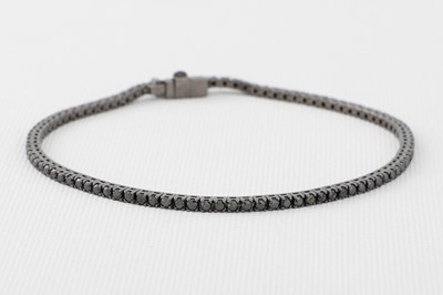 Lot 169 - A BLACK DIAMOND LINE BRACELET, mounted in...