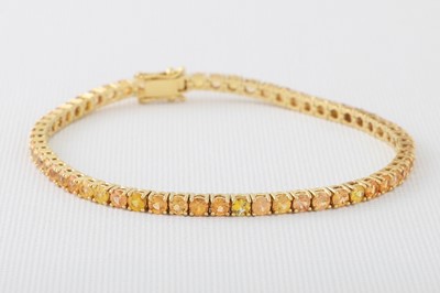 Lot 170 - A YELLOW SAPPHIRE LINE BRACELET, mounted in...