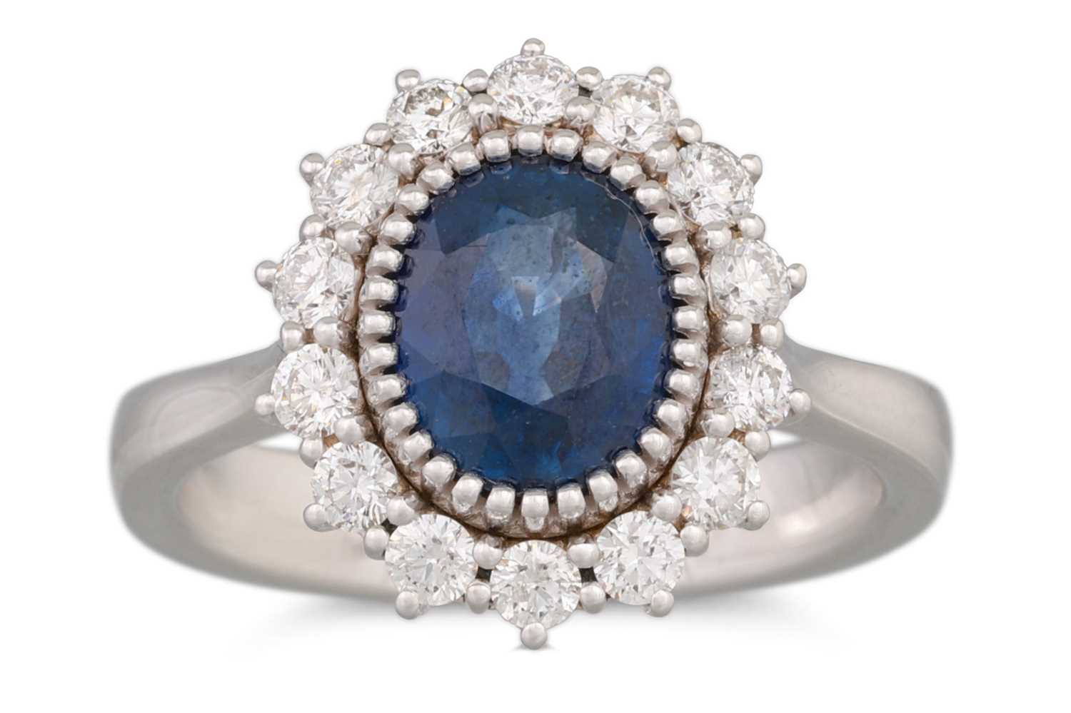 Lot 250 - A SAPPHIRE AND DIAMOND RING, the oval sapphire...