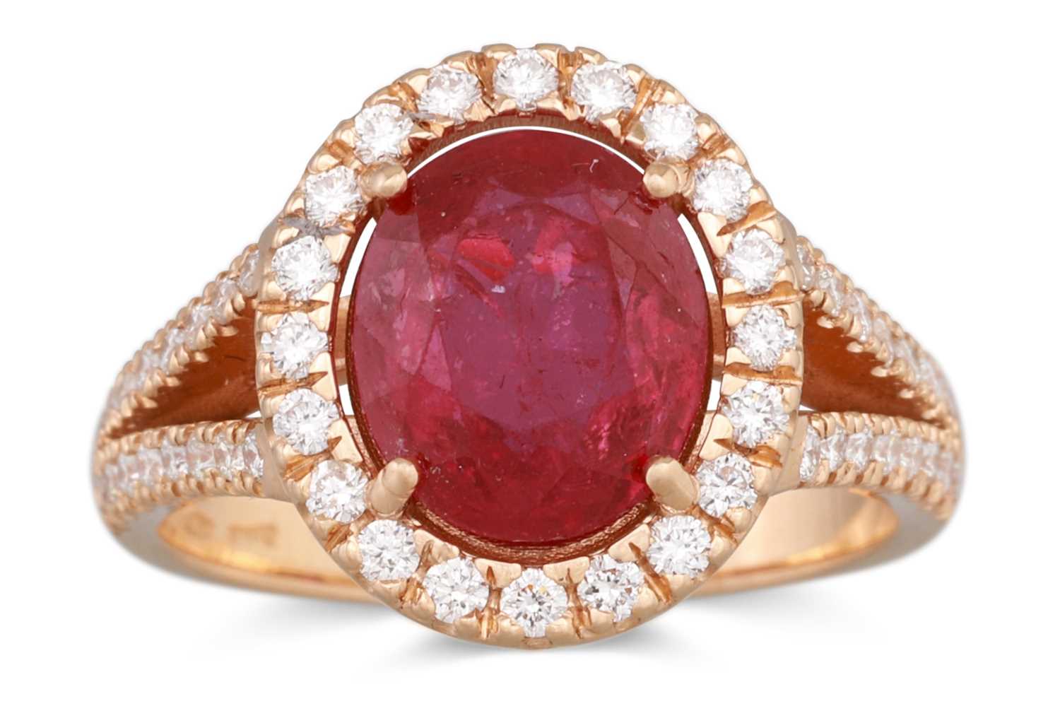 Lot 256 - A RUBY CLUSTER RING, the oval ruby to diamond...