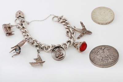 Lot 3 - A SILVER CHARM BRACELET, with various charms...