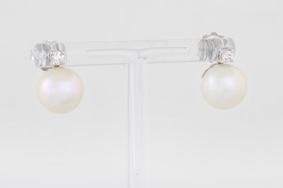 Lot 109 - A PAIR OF PEARL AND DIAMOND EARRINGS, mounted...