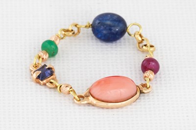 Lot 143 - A CORAL, SAPPHIRE AND RUBY RING, chain from,...