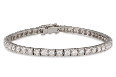 Lot 336 - A DIAMOND LINE BRACELET, the brilliant cut...