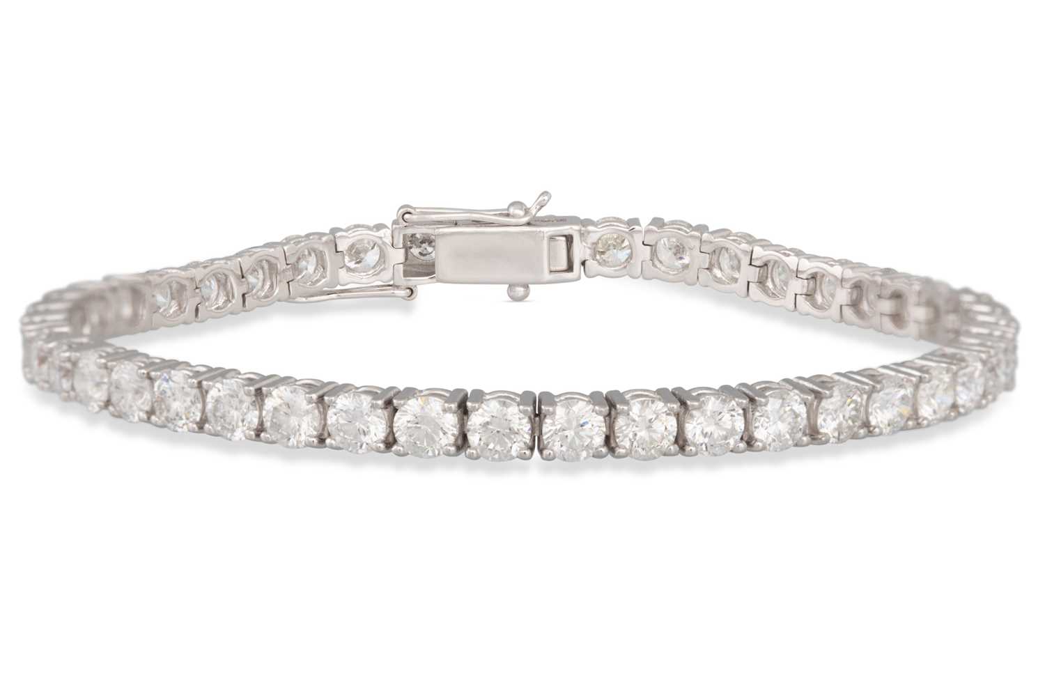 Lot 213 - A DIAMOND LINE BRACELET, the brilliant cut...