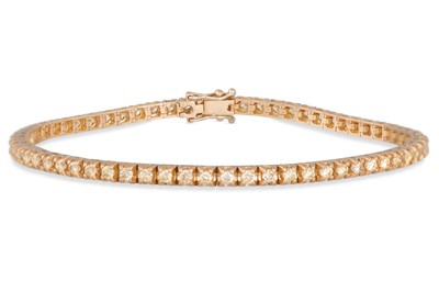 Lot 214 - A DIAMOND LINE BRACELET, the brilliant cut...