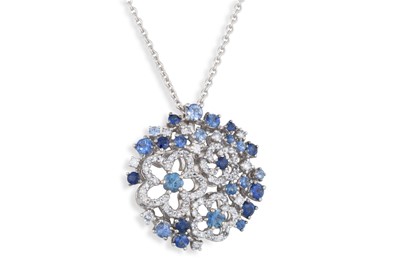 Lot 218 - A DIAMOND AND SAPPHIRE CLUSTER PENDANT, of...