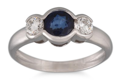 Lot 222 - A DIAMOND AND SAPPHIRE THREE STONE RING, the...