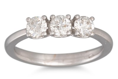 Lot 226 - A DIAMOND THREE STONE RING, mounted in white...