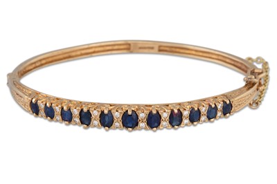 Lot 198 - A SAPPHIRE AND DIAMOND SET HINGED BANGLE,...