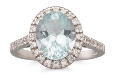 Lot 242 - AN AQUAMARINE AND DIAMOND RING, the oval...