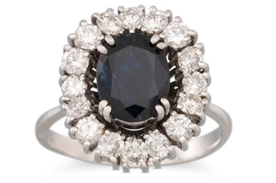 Lot 225 - A SAPPHIRE AND DIAMOND CLUSTER RING, the oval...