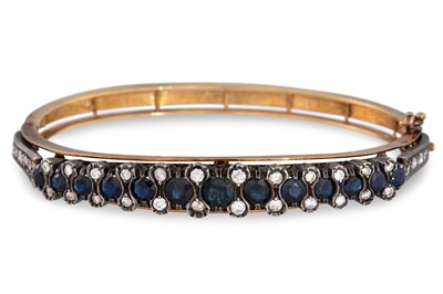 Lot 333 - A SAPPHIRE AND DIAMOND BANGLE, each oval...