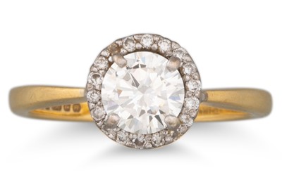 Lot 173 - A DIAMOND SOLITAIRE RING, with a diamond halo...