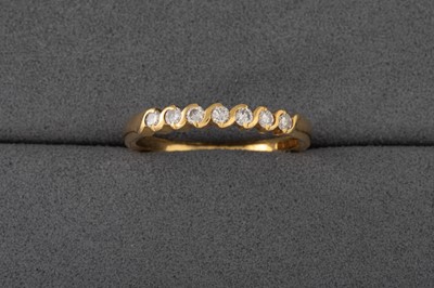 Lot 83 - A DIAMOND SET HALF ETERNITY RING, mounted in...