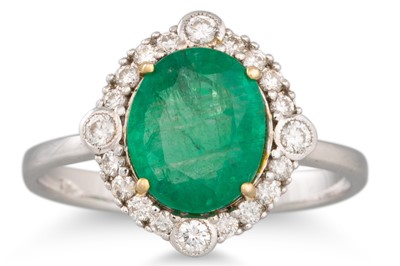 Lot 124 - AN EMERALD AND DIAMOND CLUSTER RING, oval...