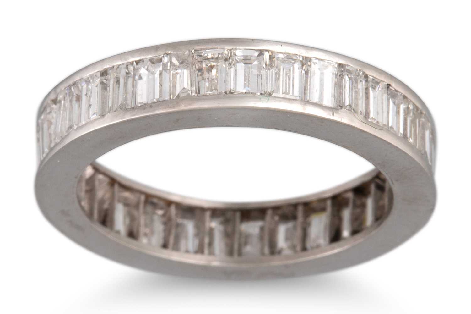 Lot 318 - A BAGUETTE DIAMOND SET ETERNITY RING, channel...