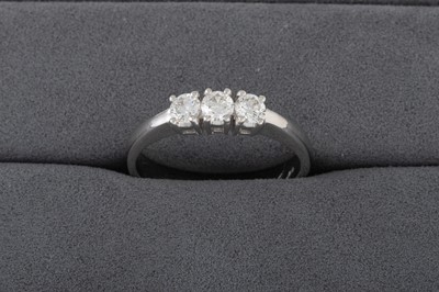 Lot 153 - A DIAMOND THREE STONE RING, the brilliant cut...