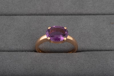 Lot 17 - A ROSE GOLD AMETHYST RING, the oval amethyst...