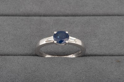 Lot 18 - A DIAMOND AND SAPPHIRE RING, the oval sapphire...