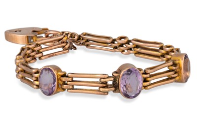 Lot 81 - AN ANTIQUE GOLD GATE BRACELET, set with three...