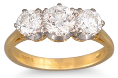 Lot 133 - A DIAMOND THREE STONE RING, the brilliant cut...