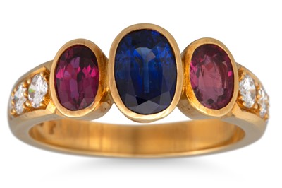 Lot 143 - A SAPPHIRE AND RUBY THREE STONE RING, the oval...