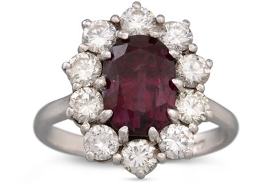 Lot 2 - A RUBY AND DIAMOND CLUSTER RING, mounted in...