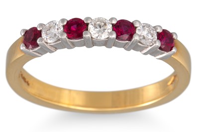 Lot 354 - A DIAMOND AND RUBY SEVEN STONE RING, mounted...