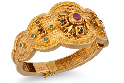 Lot 148 - A LALOUNIS MULTI GEM SET BANGLE, Eastern style,...