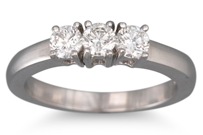 Lot 247 - A THREE STONE DIAMOND RING, the brilliant cut...