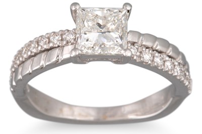 Lot 254 - A PRINCESS CUT DIAMOND SOLITAIRE RING, mounted...