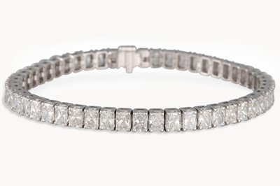 Lot 255 - A DIAMOND LINE BRACELET, the radiant cut...