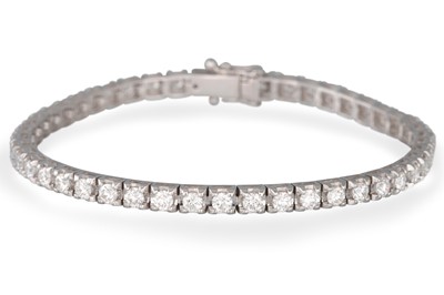 Lot 256 - A DIAMOND LINE BRACELET, the brilliant cut...