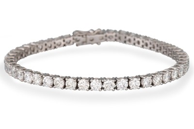 Lot 257 - A DIAMOND LINE BRACELET, the brilliant cut...