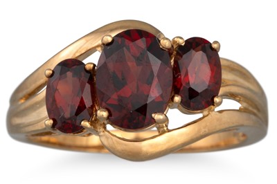 Lot 156 - A THREE STONE GARNET RING, mounted in 9ct gold,...