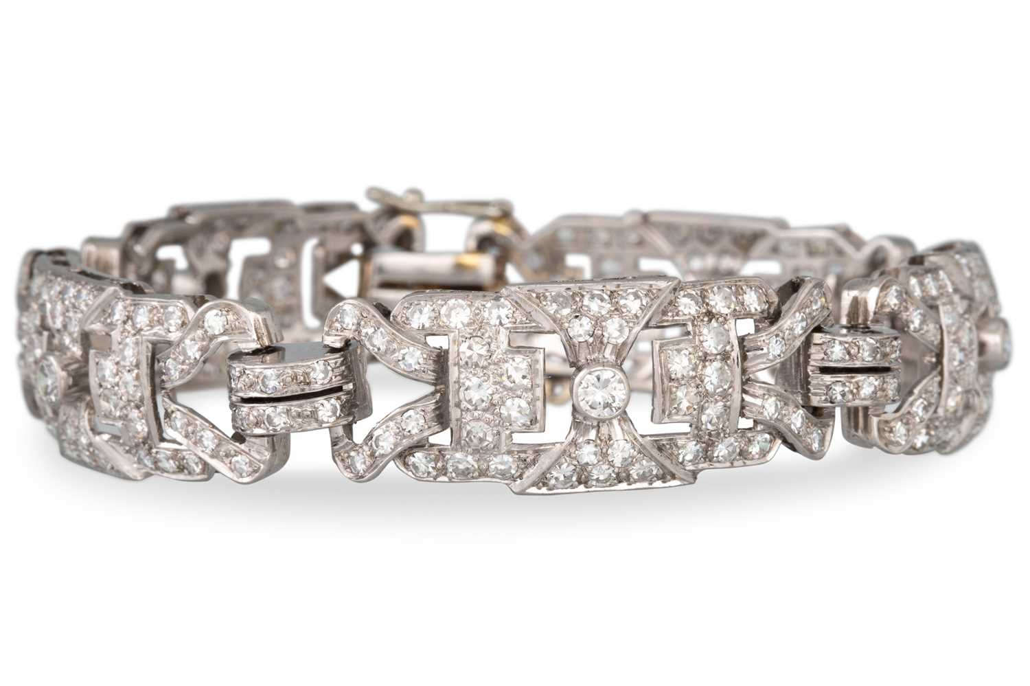 Lot 271 - A DIAMOND COCKTAIL BRACELET, shaped open work...