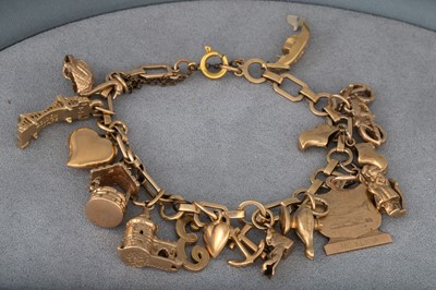 Lot 291 - A 9CT GOLD CHARM BRACELET, various charms,...