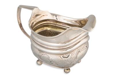 Lot 394 - A GEORGE III SILVER CREAM JUG, London 1808, of...