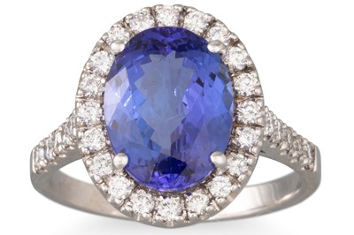 Lot 166 - A TANZANITE AND DIAMOND CLUSTER RING, the oval...