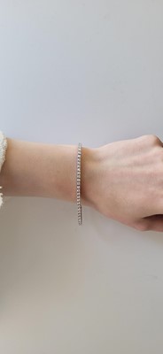 A DIAMOND LINE BRACELET, the brilliant cut...