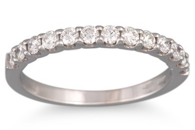 A DIAMOND HALF ETERNITY RING, the brilliant...