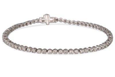 Lot 72 - A DIAMOND LINE BRACELET, the brilliant cut...